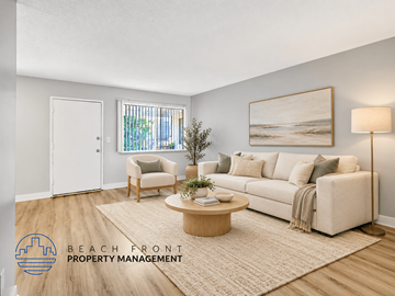Long Beach apartment for rent - A living room with a white couch, a wooden coffee table, and a painting on the wall.