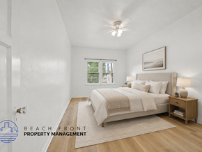 Riverside apartment for rent - A bedroom with a bed, nightstand, and window.