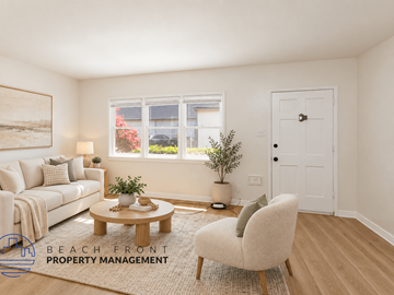 Long Beach apartment for rent - A living room with a white couch, a coffee table, a chair, and a painting on the wall.