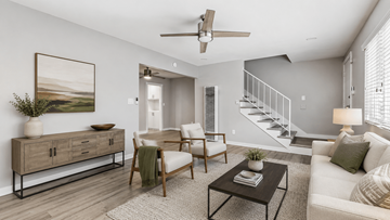 Torrance townhouse for rent - A living room with a white couch, a wooden chair, a coffee table, and a painting on the wall.