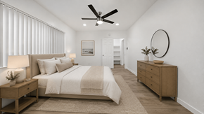 Inglewood apartment for rent - A bedroom with a large bed, a ceiling fan, and a wooden dresser.