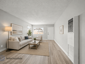 Inglewood apartment for rent - A living room with a couch, coffee table, and a window.