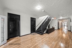 Los Angeles apartment for rent - A spacious room with wooden floors and a staircase leading to another level.