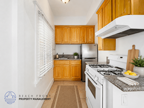 Los Angeles apartment for rent - A kitchen with wooden cabinets and white appliances.