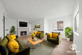 Redondo Beach apartment for rent - A living room with a fireplace, two couches, and a coffee table.