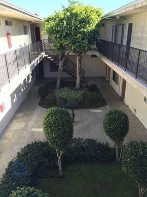 Harbor City apartment for rent - an aerial view of a courtyard with trees and bushes