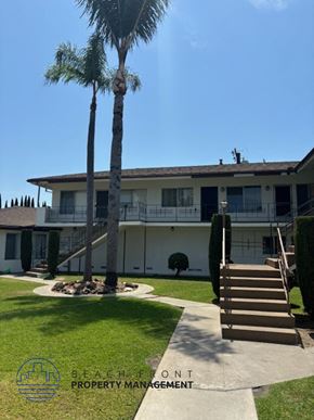Garden Grove apartment for rent - a large white house with palm trees in front of it