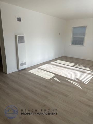 Redondo Beach apartment for rent - A room with wooden flooring and a window letting in sunlight.