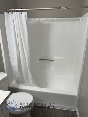 Midway townhouse for rent - a bathroom with a shower and a toilet and a shower curtain