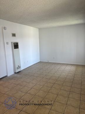 Garden Grove apartment for rent - an empty living room with a tile floor and white walls