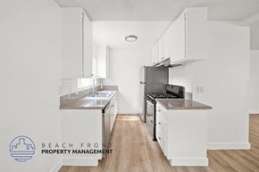 Manhattan Beach apartment for rent - A kitchen with white cabinets and a granite countertop.