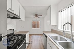 Manhattan Beach apartment for rent - A kitchen with a stove, sink, and cabinets.