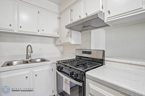 Downey apartment for rent - A modern kitchen with a stove top oven and a sink.