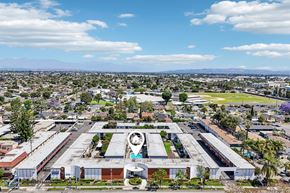 Downey apartment for rent - A large industrial building with a circular logo on the front.