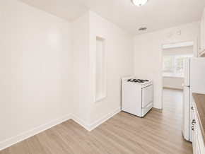 Long Beach apartment for rent - A white kitchen with a dishwasher and a refrigerator.