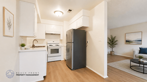 La Habra apartment for rent - A modern kitchen with a refrigerator, sink, and cabinets.