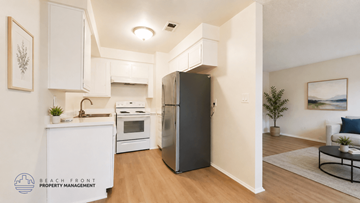 La Habra apartment for rent - A modern kitchen with a refrigerator, sink, and cabinets.