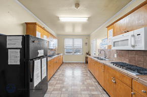 Los Angeles apartment for rent - A kitchen with black appliances and wooden cabinets.