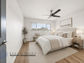 Whittier apartment for rent - A well-lit bedroom with a large bed and a ceiling fan.