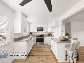 Whittier apartment for rent - A modern kitchen with white cabinets and a wooden floor.