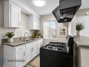 Downey apartment for rent - A modern kitchen with a black stove top oven.