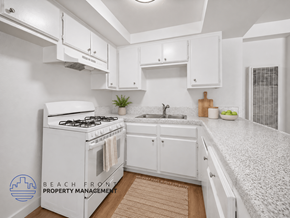 Wilmington apartment for rent - A kitchen with white cabinets and a white stove top oven.