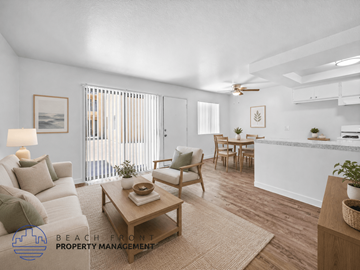 Wilmington apartment for rent - A living room with a white couch, a coffee table, and a dining table with chairs.
