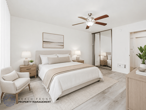 Long Beach apartment for rent - A well-lit bedroom with a large bed, a chair, and a ceiling fan.