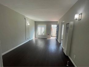 Wilmington apartment for rent - an empty living room with a hard wood floor and white walls
