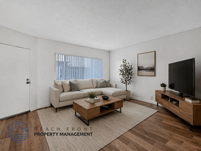 Long Beach apartment for rent - A living room with a couch, coffee table, and television.