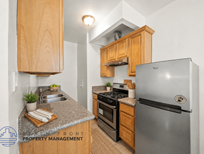 Los Angeles apartment for rent - A kitchen with a refrigerator, stove, and oven.