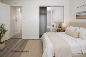 Newport Beach townhouse for rent - A bedroom with a bed, a plant, and a painting on the wall.