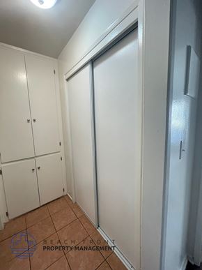 Lynwood apartment for rent - A white closet with a sliding door and two doors.