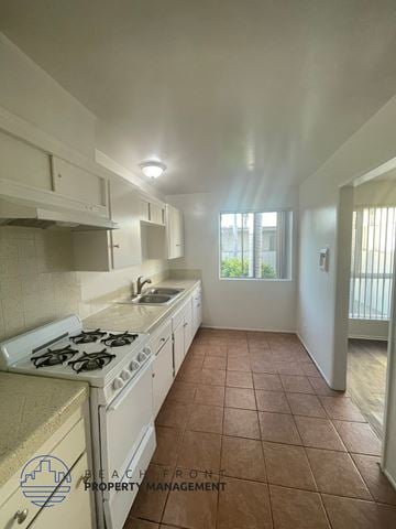 Lynwood apartment for rent - A kitchen with a stove top oven and a sink.