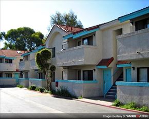 Paramount apartment for rent - Apartment building with blue doors and staircases.