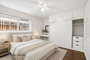 Downey apartment for rent - A bedroom with a bed, nightstands, and a window with blinds.