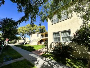 Long Beach apartment for rent - A building with a tree in front of it.