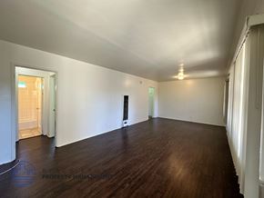 Long Beach apartment for rent - A room with wooden floors and white walls.