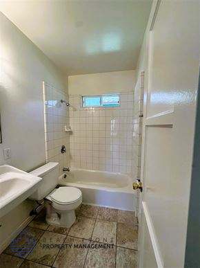 Long Beach apartment for rent - A bathroom with a toilet, sink, and bathtub.