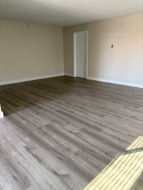 Garden Grove apartment for rent - A room with a wooden floor and a white door.