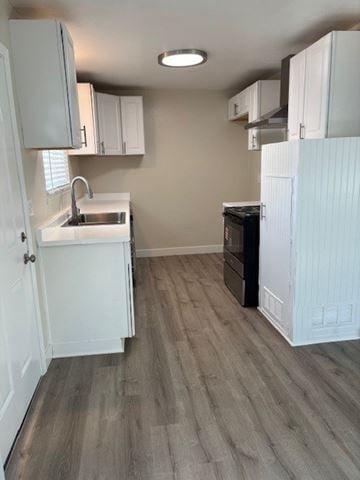 Garden Grove apartment for rent - A kitchen with white cabinets and a black oven.