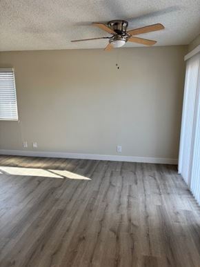 Garden Grove apartment for rent - A room with a ceiling fan and light fixture.