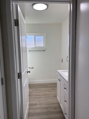 Garden Grove apartment for rent - A white bathroom with a sink and a window.