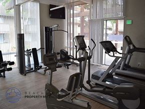 Garden Grove apartment for rent - A gym with treadmills, elliptical machines and a television.