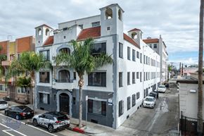 Long Beach apartment for rent - A street view of a building with cars parked in front.