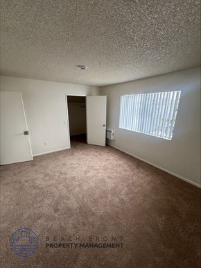 Wilmington apartment for rent - an empty room with a door to a closet and a window