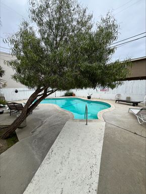 Torrance apartment for rent - a swimming pool with a tree next to it