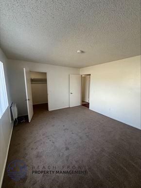 Wilmington apartment for rent - an empty living room with carpet and white walls