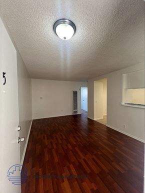 Wilmington apartment for rent - an empty living room with a wood floor and a ceiling light