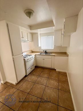 Wilmington apartment for rent - a kitchen with white appliances and a sink and a refrigerator